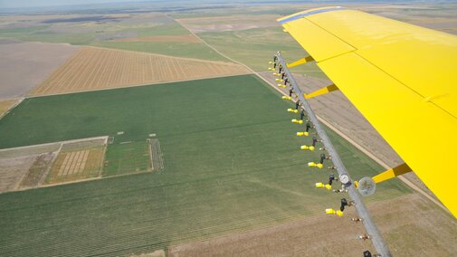 flying in spray plane